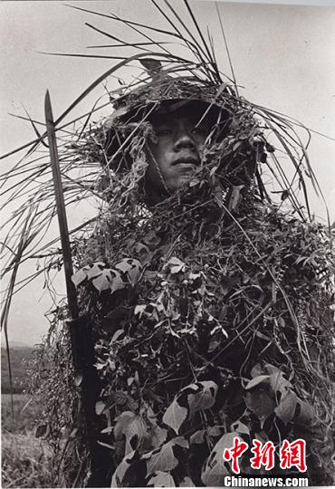  1943年3月31日这名中国远征军步兵的伪装包扎如网，因此它一直可以保留在身上并且从头盔到他的臀部全部被覆蓋隐蔽。　资料图　摄